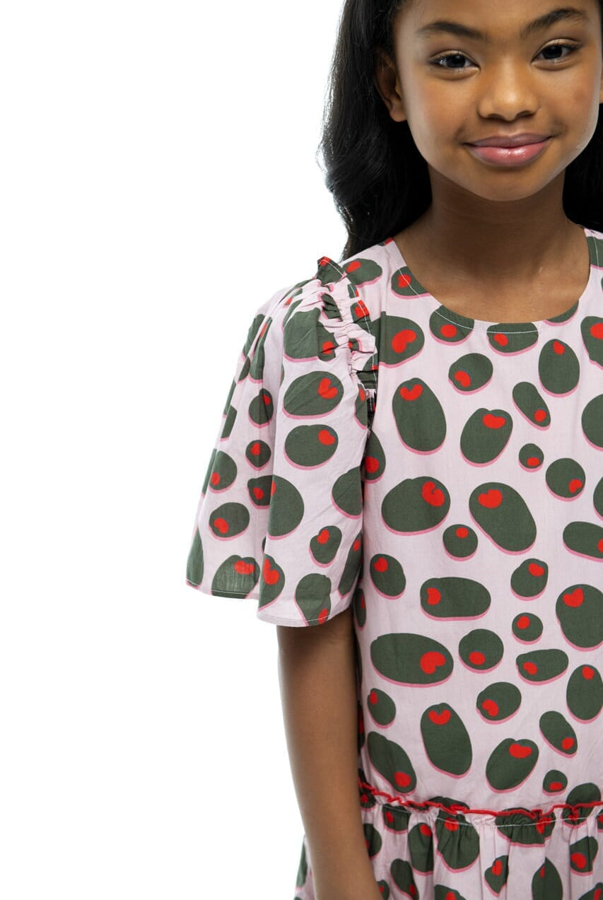 Upclose picture of girl smiling to show design of Ruby Olive Rose dress.