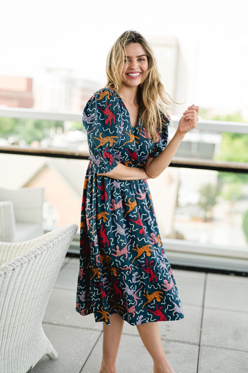 Woman wearing Briton Courts Whit Flounce Navy dress.