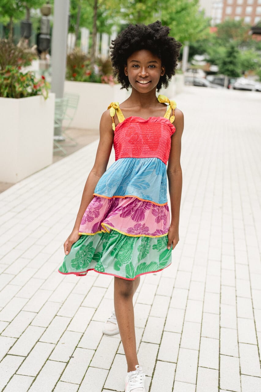girl wearing rainbow tiered dress - briton court