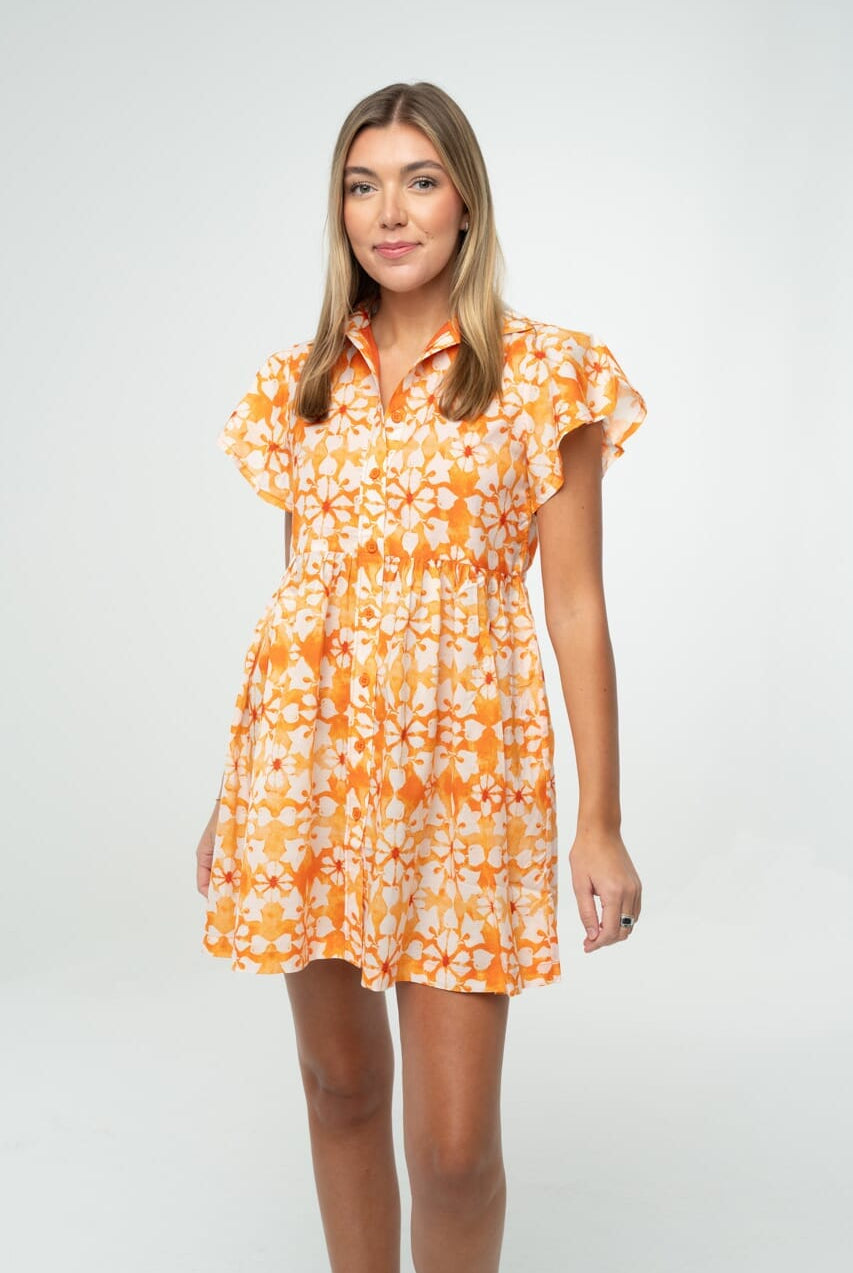 "Orange and white floral gameday babydoll dress with flutter sleeves and button front, styled for tailgate or team spirit."