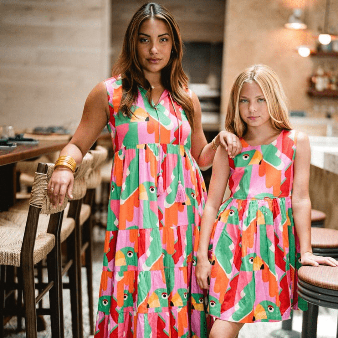a woman and girl in colorful dresses