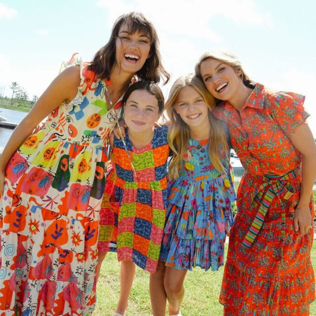 women and girls smiling in briton court dresses