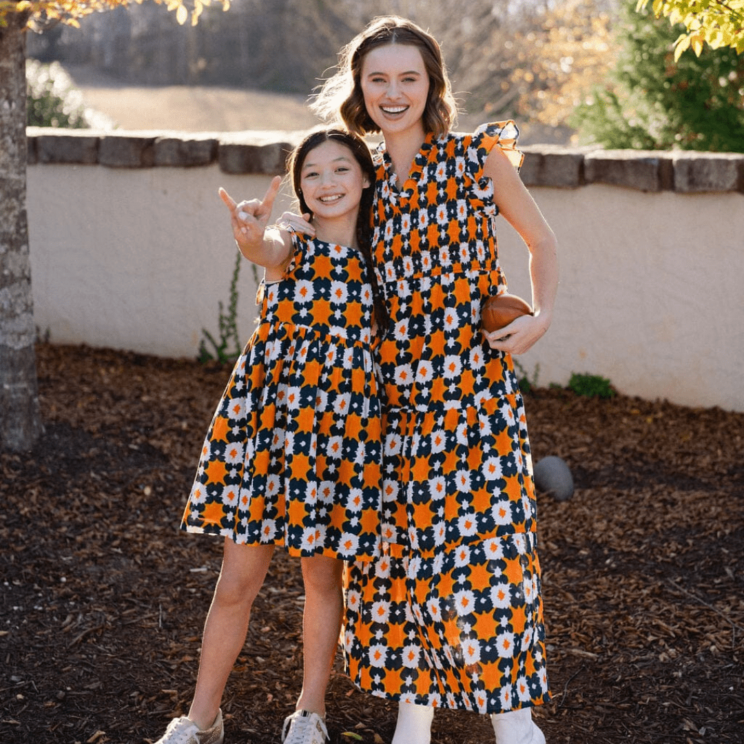 girl and woman smiling wearing briton court gameday dresses