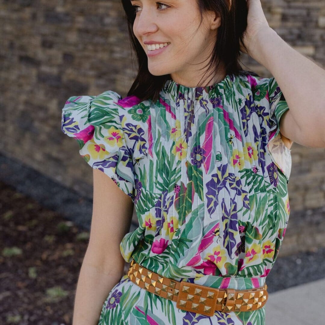 Woman wearing vibrant colored tropical patterned top