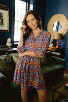 Model wearing Briton Court Hazel Mini Dress in Vintage Equestrian Diamond print, featuring jewel-tone diamond shapes and subtle equestrian motifs.
