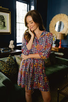 Model wearing Briton Court Hazel Mini Dress in Vintage Equestrian Diamond print, featuring jewel-tone diamond shapes and subtle equestrian motifs.