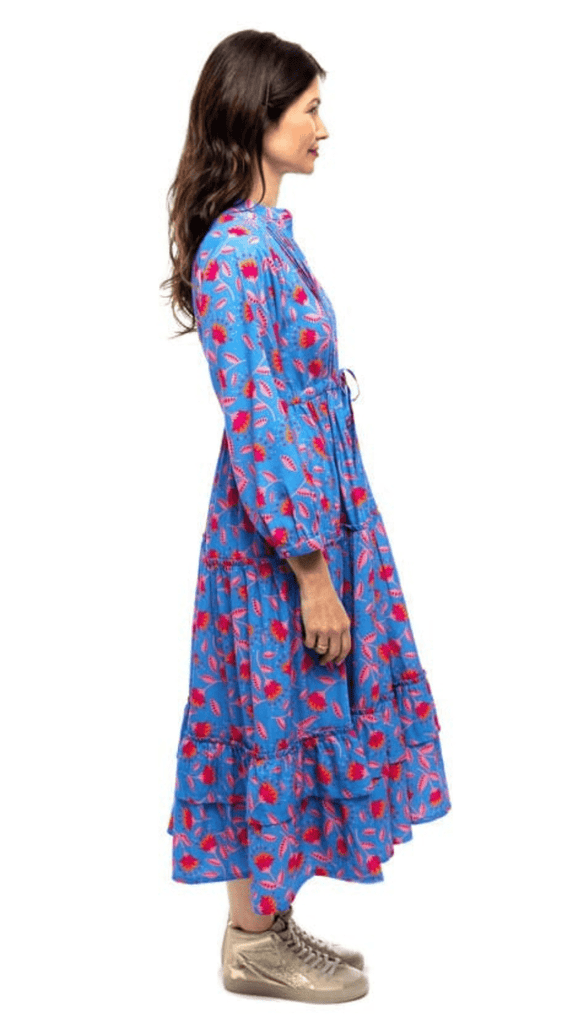 Woman turned to the side while wearing Briton Courts Blue Floral Lotus midi dress.