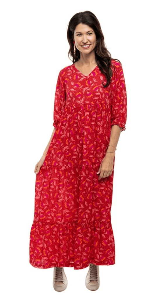 Woman smiling while wearing Briton Courts Wallflower Cherry Red maxi dress.