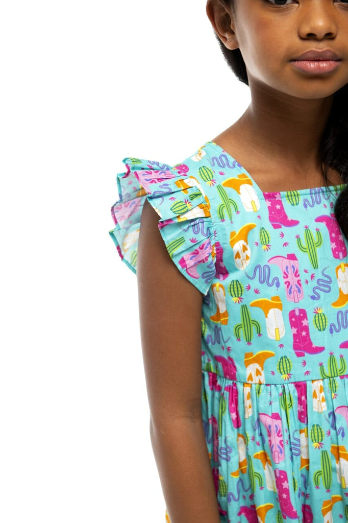 Close up of girl wearing Annie Cowboy dress in the color turquoise