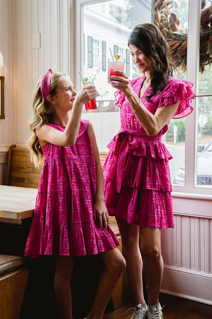 Woman and girl smiling while wearing Delilah Ruffle Magenta dress.
