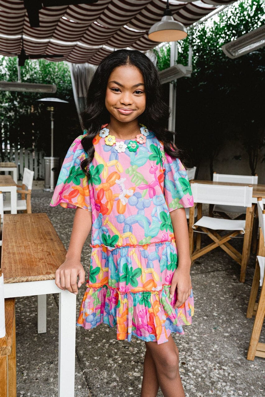 Girl smiling while wearing Kennedy Balloon Animal dress.