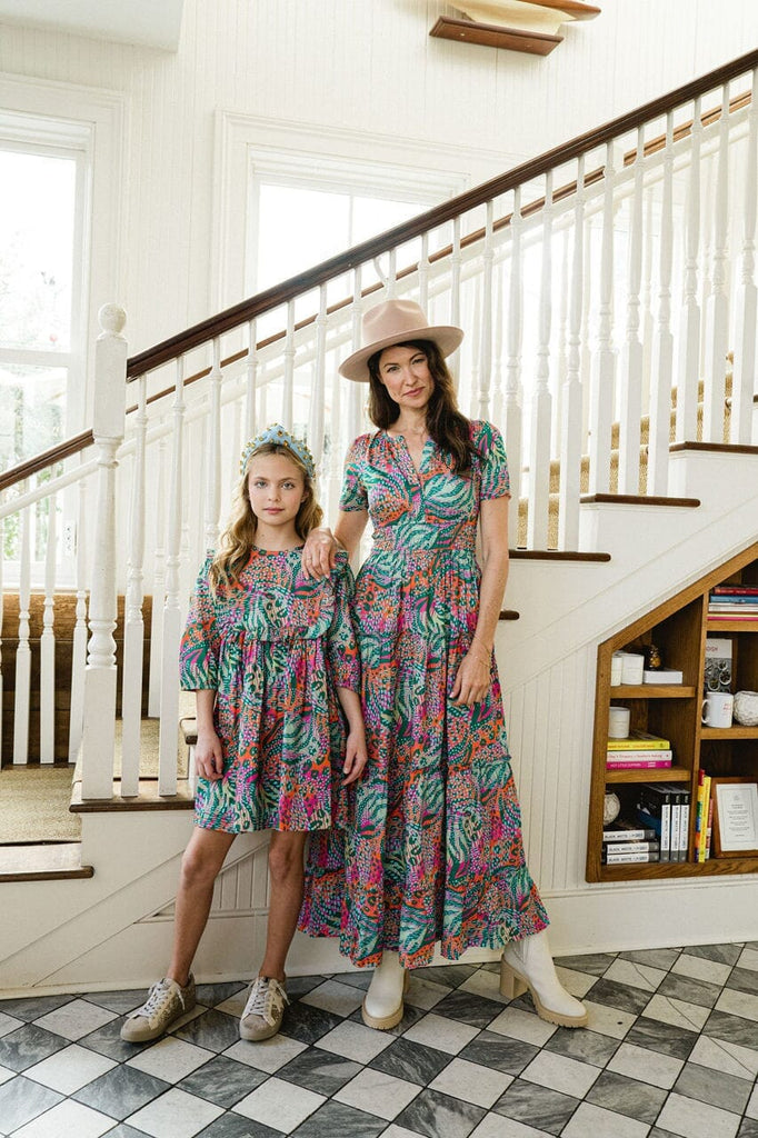 Woman and girl wearing matching Willow Ruffle Bib dress.