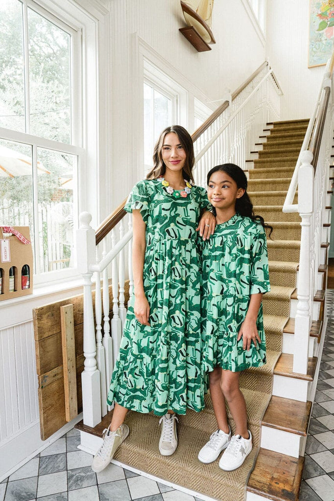 Girl and women standing on stairs while matching in Easy cheetah- Emerald dress.