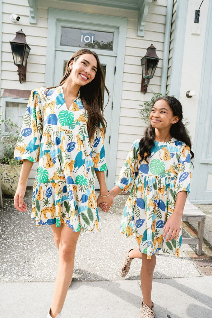 Woman and girl smiling while matching wearing Hattie Tropical Leaves dress.