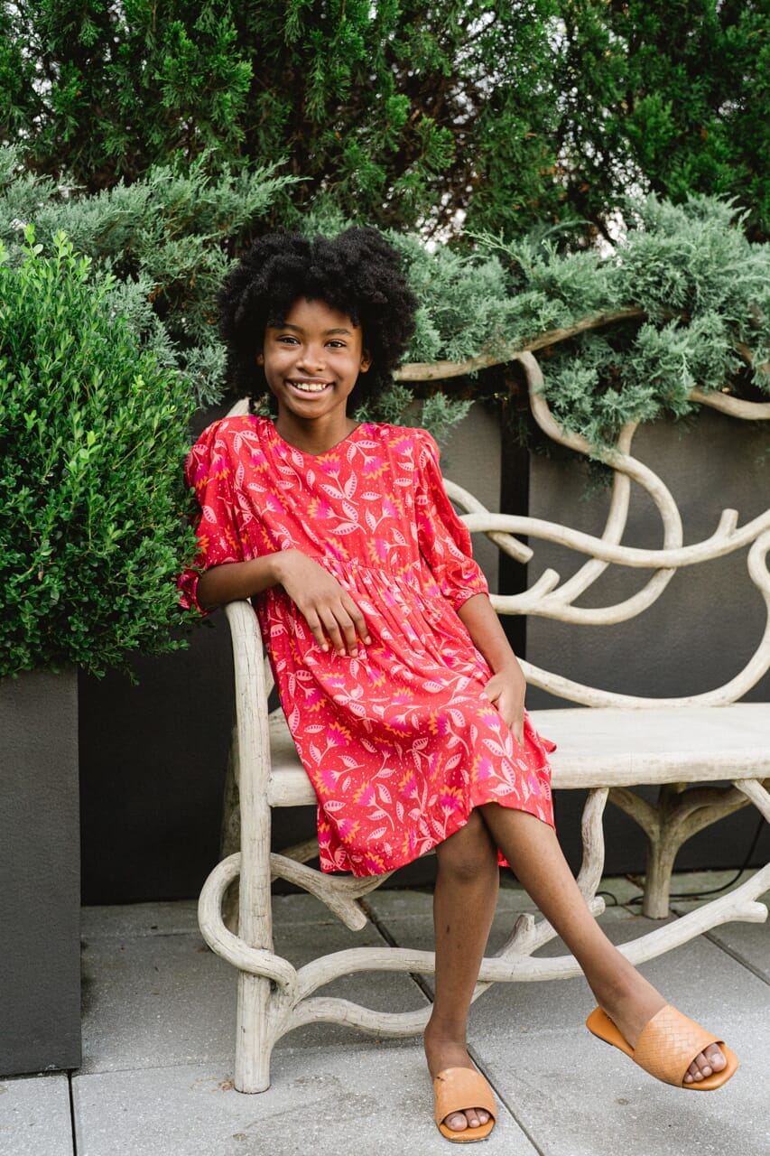 Girl wearing Briton Courts Wallflower Cherry Red dress.