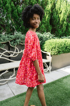 Girl wearing Briton Courts Wallflower Cherry Red dress.