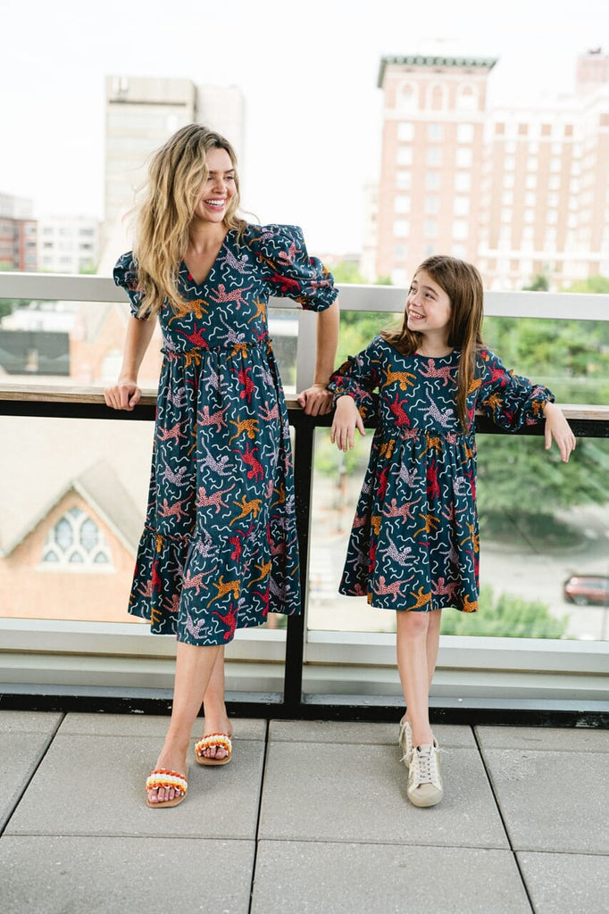 Woman and girl wearing Briton Courts Whit Flounce Navy dress.
