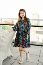 Girl wearing Briton Courts Savannah Navy dress.