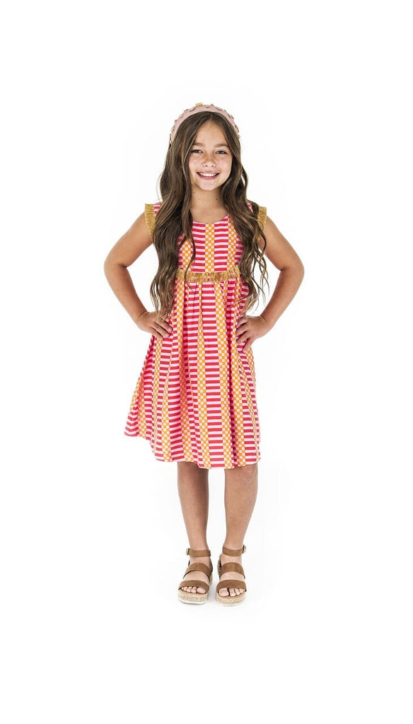 Girl smiling while her hands on her hips showing the Fringe Flamingo Pink dress