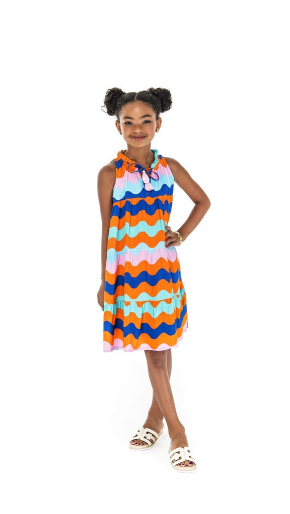 little girl standing in a colorful dress